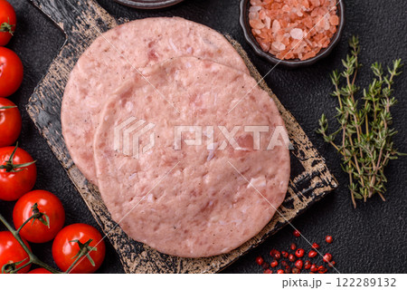 Raw chicken burger cutlet with salt, spices and herbs 122289132