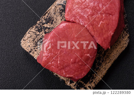 Raw beef eye steak round with salt, spices and herbs Raw beef eye steak round with salt, spices and herbs 122289380