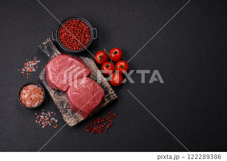 Raw beef eye steak round with salt, spices and herbs Raw beef eye steak round with salt, spices and herbs 122289386
