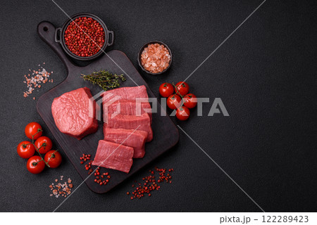 Juicy raw beef cut into slices with salt and spices Juicy raw beef cut into slices with salt and spices 122289423