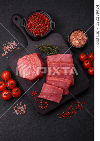 Juicy raw beef cut into slices with salt and spices Juicy raw beef cut into slices with salt and spices 122289424