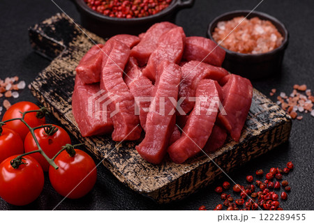Juicy raw beef cut into slices with salt and spices Juicy raw beef cut into slices with salt and spices 122289455