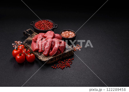 Juicy raw beef cut into slices with salt and spices Juicy raw beef cut into slices with salt and spices 122289458
