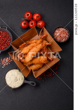Hot crispy shrimp breaded with salt and spices with white sauce Hot crispy shrimp breaded with salt and spices with white sauce 122289539