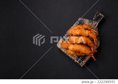 Hot crispy shrimp breaded with salt and spices with white sauce 122289541