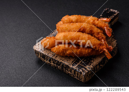 Hot crispy shrimp breaded with salt and spices with white sauce Hot crispy shrimp breaded with salt and spices with white sauce 122289543