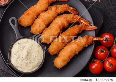 Hot crispy shrimp breaded with salt and spices with white sauce Hot crispy shrimp breaded with salt and spices with white sauce 122289570