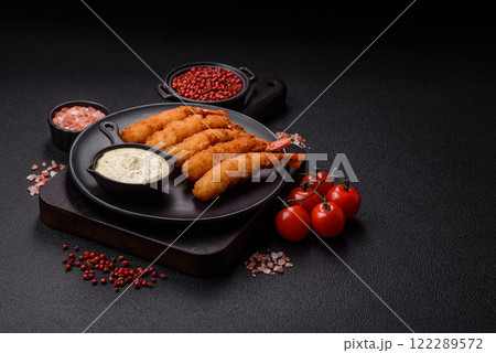 Hot crispy shrimp breaded with salt and spices with white sauce Hot crispy shrimp breaded with salt and spices with white sauce 122289572