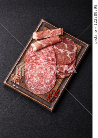Antipasto jamon, prosciutto, sausage, sliced with tomatoes, salt and spices 122289598
