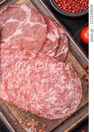Antipasto jamon, prosciutto, sausage, sliced with tomatoes, salt and spices Antipasto jamon, prosciutto, sausage, sliced with tomatoes, salt and spices 122289604