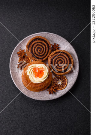 Sweet dessert danish covered with white cream and citrus, with cream filling 122290062