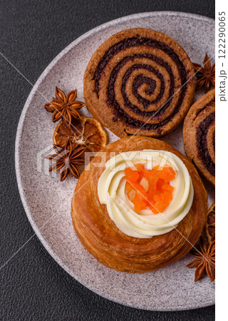 Sweet dessert danish covered with white cream and citrus, with cream filling 122290065