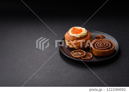 Sweet dessert danish covered with white cream and citrus, with cream filling Sweet dessert danish covered with white cream and citrus, with cream filling 122290092