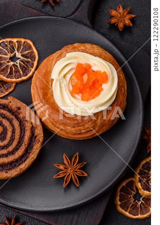 Sweet dessert danish covered with white cream and citrus, with cream filling Sweet dessert danish covered with white cream and citrus, with cream filling 122290108