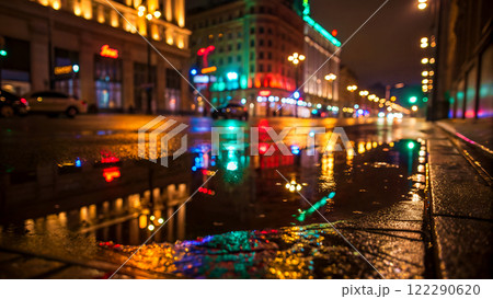 Close-up of wet asphalt road in a city at night reflected of colorful lights from buildings and streetlamps. Created with Generative AI. 122290620