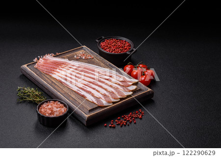 Fresh raw bacon sliced with spices and herbs 122290629