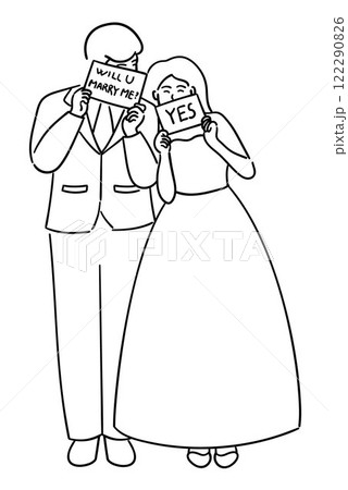 Groom is holding a sign that says Will you marry me, and the bride is holding a sign that says Yes, a cute couple on their wedding day, bride and groom  122290826