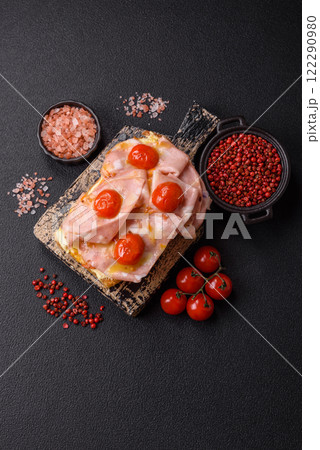 Sandwich with brioche, meat, melted cheese, ham, tomatoes, salt, spices and herbs Sandwich with brioche, meat, melted cheese, ham, tomatoes, salt, spices and herbs 122290980