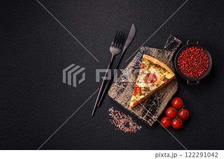Delicious crispy quiche cut into slices with cheese, broccoli, tomatoes 122291042