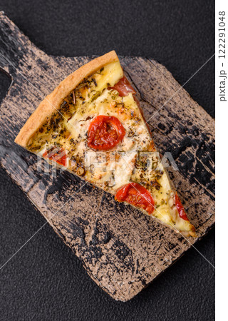 Delicious crispy quiche cut into slices with cheese, broccoli, tomatoes Delicious crispy quiche cut into slices with cheese, broccoli, tomatoes 122291048