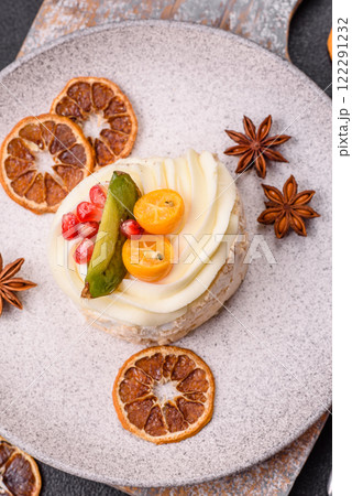 Piece of sweet meringue with citrus, kiwi and pomegranate seeds 122291232