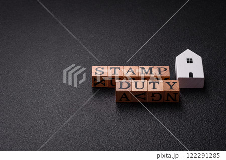 The inscription Stamp Duty made of wooden cubes on a plain background The inscription Stamp Duty made of wooden cubes on a plain background 122291285
