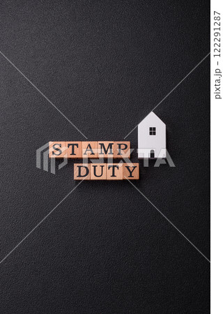 The inscription Stamp Duty made of wooden cubes on a plain background 122291287