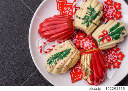Sweet Madeleines desserts covered with chocolate in Christmas colors 122291336