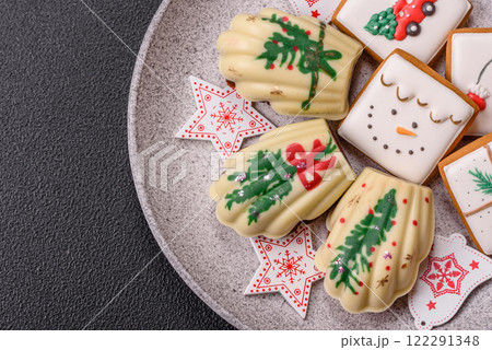 Sweet Madeleines desserts covered with chocolate in Christmas colors Sweet Madeleines desserts covered with chocolate in Christmas colors 122291348