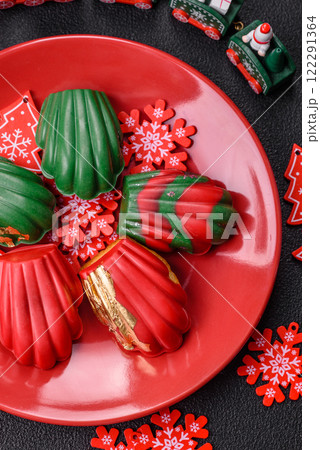 Sweet Madeleines desserts covered with chocolate in Christmas colors Sweet Madeleines desserts covered with chocolate in Christmas colors 122291364