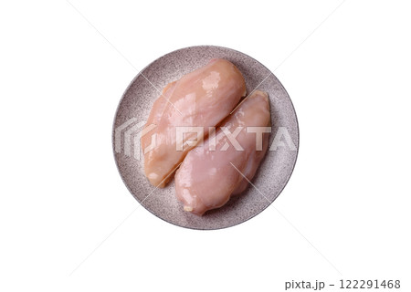 Pieces of raw chicken or turkey fillet with salt, spices and herbs Pieces of raw chicken or turkey fillet with salt, spices and herbs 122291468