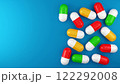 bright and colorful pills on a blue background. 3d illustration. background for a presentation about medicine and health 122292008