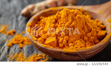 Fresh turmeric powder in wooden bowl on dark background for culinary use. Generative AI 122292543