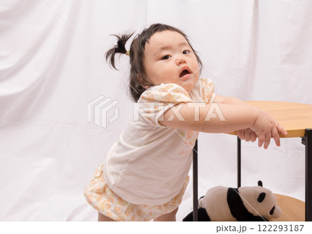 【テーブルでつかまり立ちをするツインテールの赤ちゃん】 【テーブルでつかまり立ちをするツインテールの赤ちゃん】 122293187