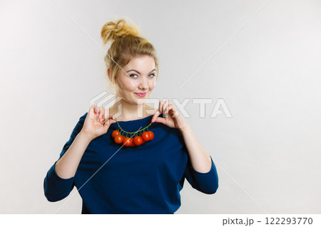 Woman holding fresh cherry tomatoes 122293770