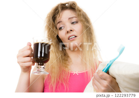 Tired woman holding toothbrush and coffee 122293779