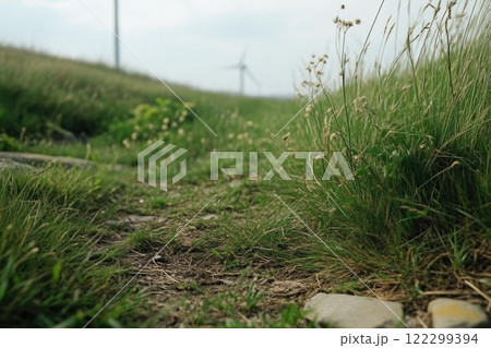 Wind Power Plants Amidst Field of Grass Wind Power Plants Amidst Field of Grass 122299394