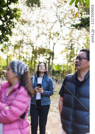 Three friends walking in the park in the morning. Three friends walking in the park in the morning. 122300668