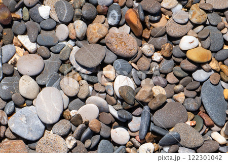 Stone background. Pebble stones texture. Multi-colored stones background Stone background. Pebble stones texture. Multi-colored stones background 122301042