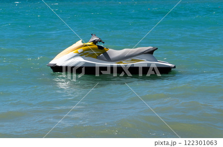 Blue sea and a jet ski floating on the sea. Water scooter is in the blue sea. 122301063