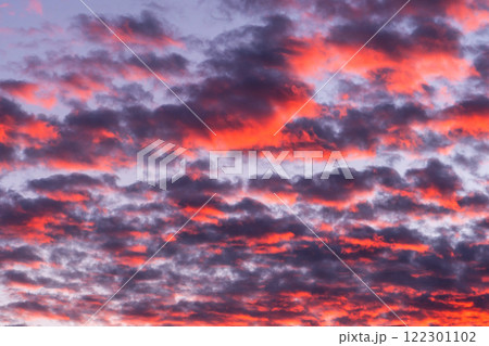 Sunset sky texture background. Cloudscape. Orange texture of clouds. Sunrise or sunset over clouds 122301102