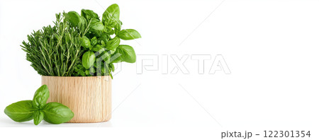 Fresh garden herbs in natural wooden pot, showcasing vibrant green basil, rosemary, and other herbs, perfect for cooking and decoration 122301354