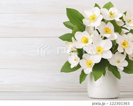 Fresh white flowers in vase with green leaves create serene atmosphere. delicate petals and vibrant yellow centers add touch of elegance 122301363