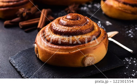 Swedish cinnamon buns or rolls. Freshly baked buns on a black stone table 122301554