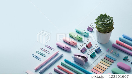 Stationery banner with pastel colored office supplies neatly laid out on light blue background. Place for your text. 122301607