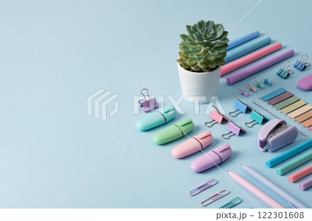 Stationery banner with pastel colored office supplies neatly laid out on light blue background. Place for your text. 122301608