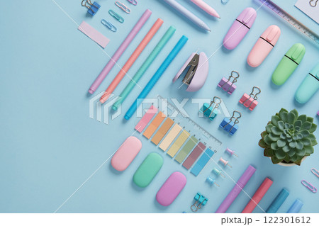 Stationery banner with pastel colored office supplies neatly laid out on light blue background. Place for your text. Stationery banner with pastel colored office supplies neatly laid out on light blue background. Place for your text. 122301612