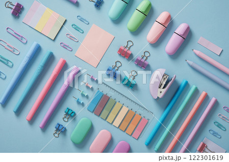 Stationery background with pastel-colored office supplies neatly arranged on a light blue background. Workplace organization. Back to school concept. 122301619