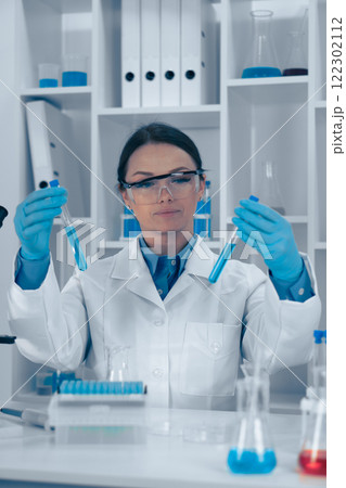 A Laboratory Scientist is meticulously analyzing various chemical reactions utilizing test tubes to explore the intricacies of biochemistry and chemistry through innovative experiments and research A Laboratory Scientist is meticulously analyzing various chemical reactions utilizing test tubes to explore the intricacies of biochemistry and chemistry through innovative experiments and research 122302112