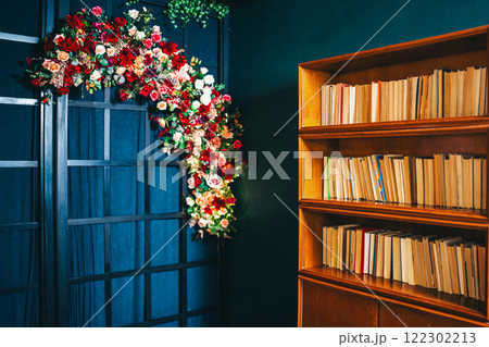 bookcase with books on dark wall background. photo zone with books bookcase with books on dark wall background. photo zone with books 122302213